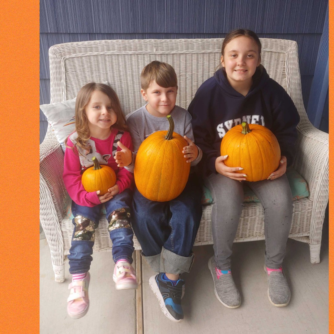 Me and my cute siblings with our pumpkins at our grandparents house.